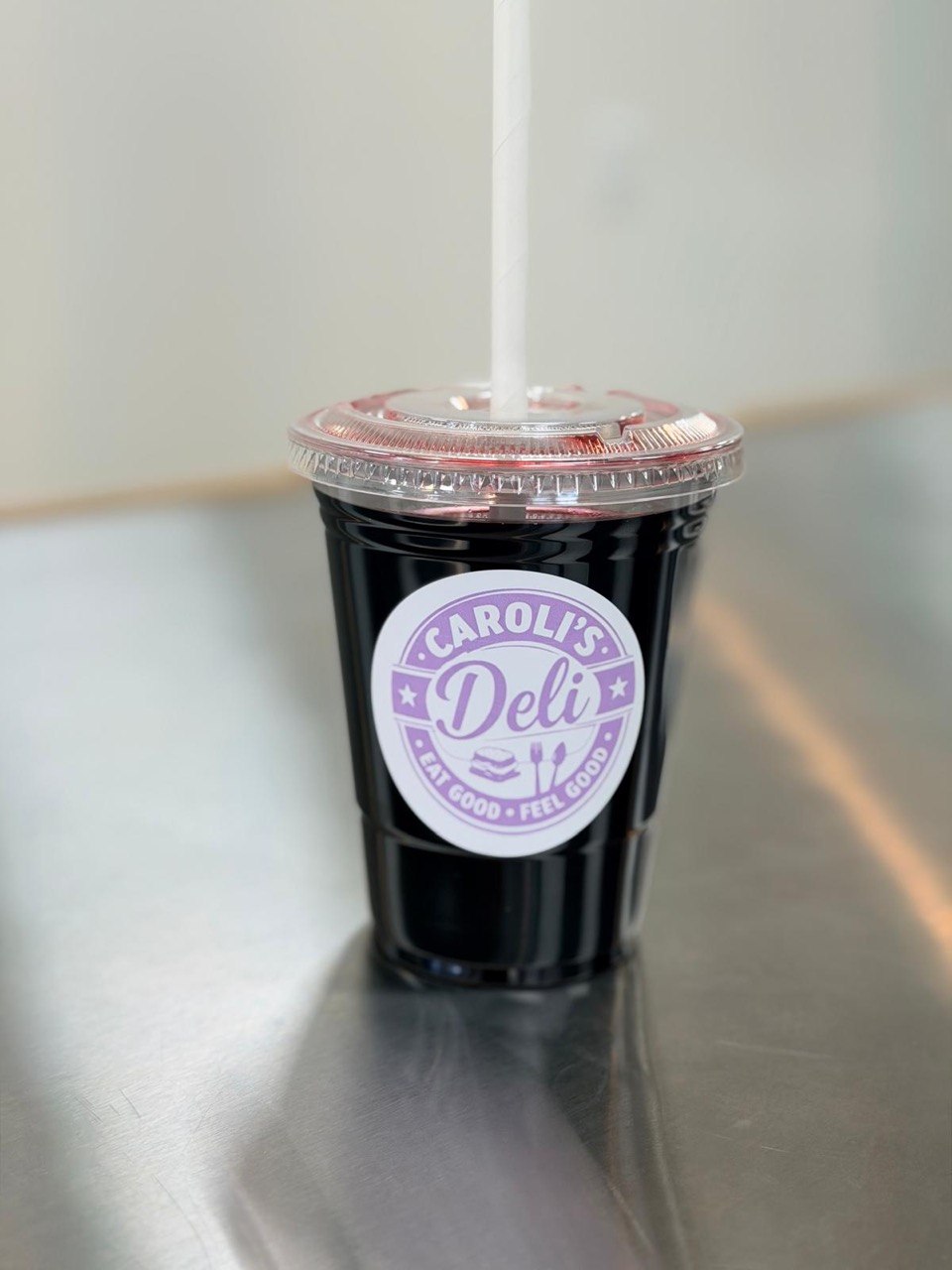 Jamaica drink with Carolis Deli logo